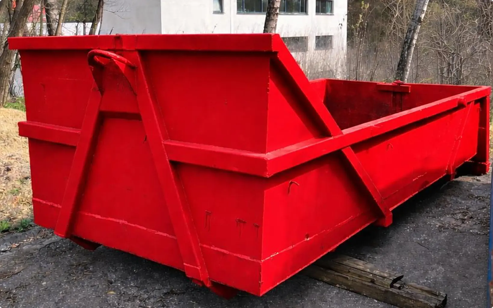 Duży czerwony kontener budowlany na zewnątrz – wynajem kontenerów na śmieci
